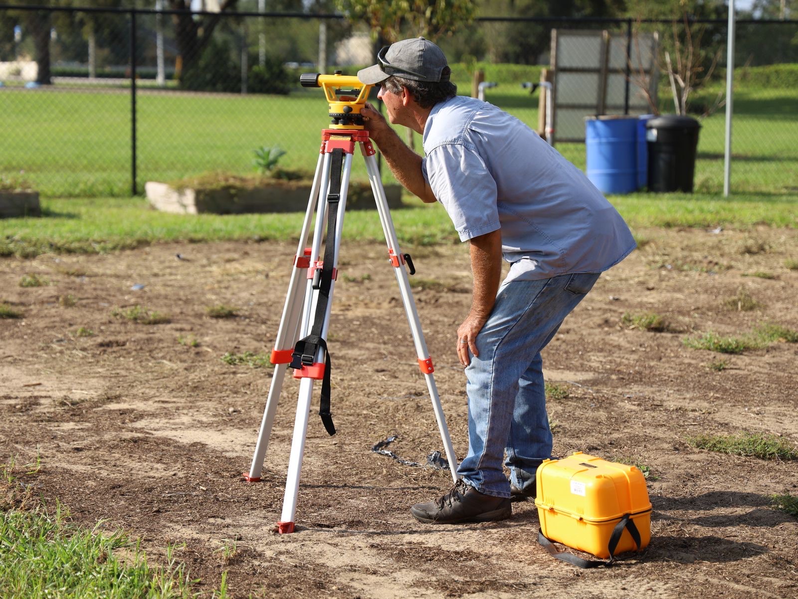 Surveyor carrying out a land survey